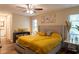 Comfortable main bedroom features a large window, ceiling fan, and view to the bathroom at 13305 Whitby Rd, Hudson, FL 34667