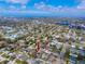 Expansive aerial view showcases this house nestled in a vibrant neighborhood with easy access to urban amenities and stunning waterfront views at 1579 Magnolia Dr, Clearwater, FL 33756