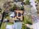 Aerial view of a home's roof with solar panels, backyard with storage shed, and neighborhood at 1579 Magnolia Dr, Clearwater, FL 33756