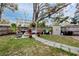 Backyard featuring an outdoor kitchen under pergola, with a seating area and storage shed at 1579 Magnolia Dr, Clearwater, FL 33756