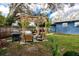 Backyard featuring outdoor furniture under a wood pergola with hanging plants and a grill at 1579 Magnolia Dr, Clearwater, FL 33756