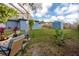 Backyard featuring a blue house with a pergola and storage shed at 1579 Magnolia Dr, Clearwater, FL 33756