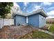 Backyard featuring a patio with a blue home and white fence at 1579 Magnolia Dr, Clearwater, FL 33756