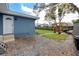 Backyard featuring a patio with a blue house, green grass, and a pergola at 1579 Magnolia Dr, Clearwater, FL 33756