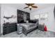 A dark grey bedroom features a skeleton tapestry and ceiling fan at 1579 Magnolia Dr, Clearwater, FL 33756