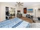 Bedroom featuring a large bed with a patterned comforter, closet with mirrored doors, and neutral walls at 1579 Magnolia Dr, Clearwater, FL 33756