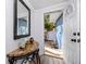 Entryway featuring tile flooring, a mirror, and a decorative table that opens to the exterior at 1579 Magnolia Dr, Clearwater, FL 33756