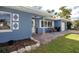 Quaint home with brick-paved front porch and blue accents, creating a welcoming entrance at 1579 Magnolia Dr, Clearwater, FL 33756