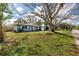 Charming home with a large tree in the front yard, offering shade and curb appeal at 1579 Magnolia Dr, Clearwater, FL 33756