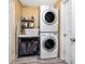 Well-equipped laundry area features a stacked washer and dryer for space-saving efficiency at 1579 Magnolia Dr, Clearwater, FL 33756