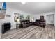 Inviting living room with new floors, two sofas, and natural light creates a cozy atmosphere at 1579 Magnolia Dr, Clearwater, FL 33756