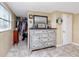 Bright main bedroom features a light dresser and a view of a walk-in closet at 1579 Magnolia Dr, Clearwater, FL 33756