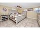 Bedroom featuring warm, bright walls, a ceiling fan and light-colored furniture at 1579 Magnolia Dr, Clearwater, FL 33756