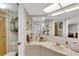Bright bathroom with a large mirror over the vanity, adjacent to the shower and toilet at 1600 Gulf Blvd # 512, Clearwater, FL 33767