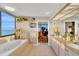 Bright bathroom featuring a large window with ocean views and double sink vanity at 1600 Gulf Blvd # 512, Clearwater, FL 33767