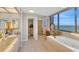 Beautiful bathroom featuring a large window with ocean views and a soaking tub at 1600 Gulf Blvd # 512, Clearwater, FL 33767