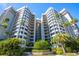 Modern condominium building with manicured landscaping and palm trees at 1600 Gulf Blvd # 512, Clearwater, FL 33767