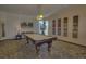 Spacious game room featuring a billiard table, artwork, and natural light at 1600 Gulf Blvd # 512, Clearwater, FL 33767