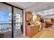 Kitchen area with wood cabinets, granite countertops, and access to a balcony with ocean views at 1600 Gulf Blvd # 512, Clearwater, FL 33767