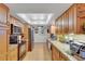 Traditional-style kitchen featuring wooden cabinetry, granite countertops, and stainless steel appliances at 1600 Gulf Blvd # 512, Clearwater, FL 33767