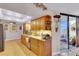 Bright kitchen with wood cabinets, granite countertops, stainless steel appliances, and balcony access at 1600 Gulf Blvd # 512, Clearwater, FL 33767