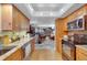 Spacious kitchen with wood cabinets, stainless steel appliances, and open view to the living and dining areas at 1600 Gulf Blvd # 512, Clearwater, FL 33767