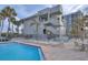 Community pool with lounge chairs and tables near residential building at 1600 Gulf Blvd # 512, Clearwater, FL 33767
