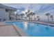 Community pool overlooking beach and ocean with palm trees at 1600 Gulf Blvd # 512, Clearwater, FL 33767