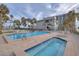 Inviting pool and hot tub area with lounge chairs, palm trees, and beautiful building views at 1600 Gulf Blvd # 512, Clearwater, FL 33767
