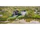 Aerial view of modern homes with pools, docks, and lush surroundings, situated by the water at 1870 Stevenson Ave, Clearwater, FL 33755