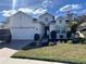 Charming single-Gathering home featuring a two-car garage, manicured lawn, and beautiful landscaping at 19309 Red Sky Ct, Land O Lakes, FL 34638