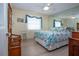 Comfortable bedroom with light wood floors, ceiling fan and a large mirror above the headboard at 2016 E View Dr, Sun City Center, FL 33573