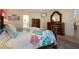 Bright bedroom featuring a wooden four-poster bed and matching dresser at 2016 E View Dr, Sun City Center, FL 33573