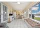 Open-concept sunroom with tile flooring, bright windows, lake view, and a seating area, seamlessly connecting indoor and outdoor spaces at 2016 E View Dr, Sun City Center, FL 33573