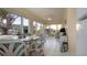 Bright sunroom with floor-to-ceiling windows, tile floors, lake view, and cozy seating at 2016 E View Dr, Sun City Center, FL 33573