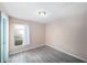 Simple bedroom featuring neutral walls, and wood-look flooring at 2041 Shadow Pine Dr, Brandon, FL 33511