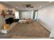 Spacious living room with a fireplace, ceiling fan, neutral walls, and doorway to a side hallway at 2391 66Th S Ter, St Petersburg, FL 33712