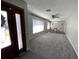 Open-concept living room featuring neutral walls, a ceiling fan, and large windows at 2391 66Th S Ter, St Petersburg, FL 33712