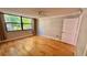 Bedroom featuring hardwood floors, ceiling fan, and large window at 2612 Pearce Dr # 211, Clearwater, FL 33764