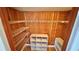 Walk-in closet with shelving and wooden paneling at 2612 Pearce Dr # 211, Clearwater, FL 33764