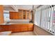Kitchen featuring wood cabinetry, granite countertops, and tiled floors at 2612 Pearce Dr # 211, Clearwater, FL 33764