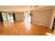 Sun-filled living room featuring hardwood floors, a decorative chandelier and sliding doors to a balcony at 2612 Pearce Dr # 211, Clearwater, FL 33764