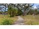 Community park with walking paths, lush landscaping, and mature trees at 2612 Pearce Dr # 211, Clearwater, FL 33764