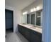 Modern bathroom featuring double sinks, quartz countertops, and a spacious walk-in shower with marble-look tile at 31857 Anchor Point Dr, Wesley Chapel, FL 33545