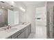 Bright bathroom with double sink vanity, marble floors and shower at 31857 Anchor Point Dr, Wesley Chapel, FL 33545