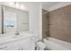 This lovely bathroom includes tiled shower and bath plus a sink with modern fixtures at 31857 Anchor Point Dr, Wesley Chapel, FL 33545