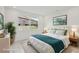 Bright bedroom featuring natural light, stylish decor, and a serene atmosphere with a plush queen bed at 31857 Anchor Point Dr, Wesley Chapel, FL 33545