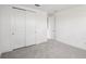 Light and airy bedroom features plush carpets, closet with bi-fold doors, and interior door at 31857 Anchor Point Dr, Wesley Chapel, FL 33545