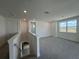 Upstairs bonus room featuring neutral carpet and natural light, ideal for recreation at 31857 Anchor Point Dr, Wesley Chapel, FL 33545