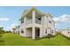 Rear exterior features multiple balconies, covered patio, and a grassy yard at 31857 Anchor Point Dr, Wesley Chapel, FL 33545